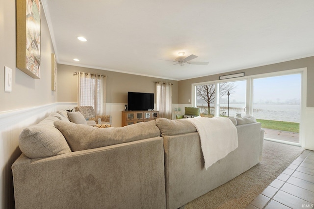 living room with ceiling fan, light tile patterned floors, and ornamental molding