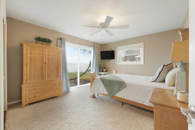 bedroom featuring access to outside, ceiling fan, and light carpet