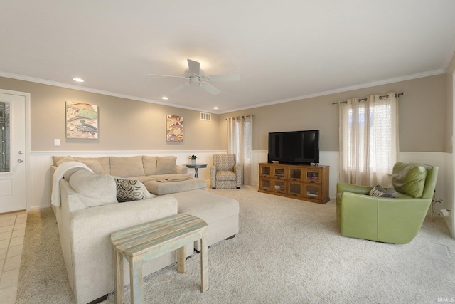 living room with tile patterned floors, ceiling fan, and crown molding