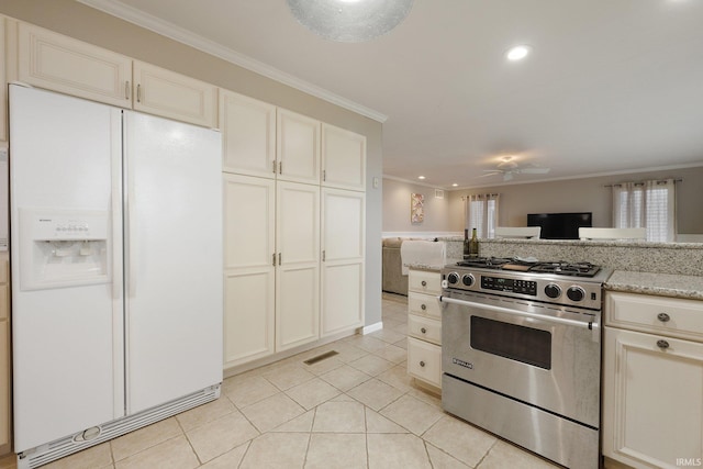 kitchen featuring crown molding, stainless steel stove, light tile patterned floors, light stone countertops, and white fridge with ice dispenser