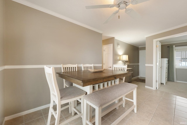 dining area with ceiling fan, light tile patterned flooring, and ornamental molding