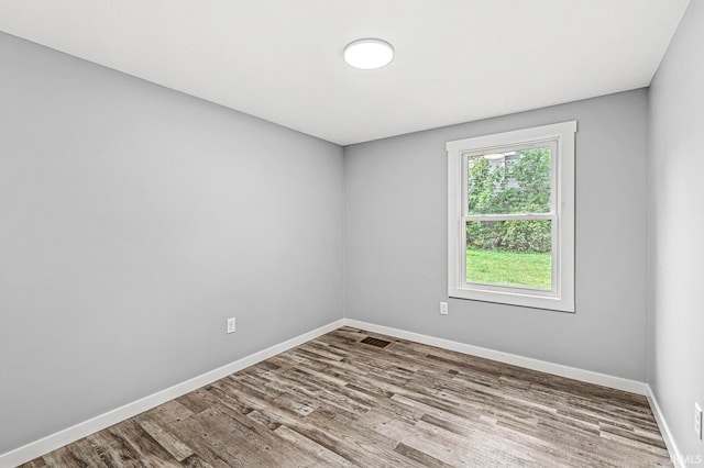 spare room with wood-type flooring