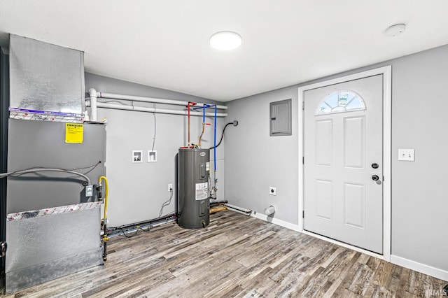 utility room with electric panel, heating unit, and water heater