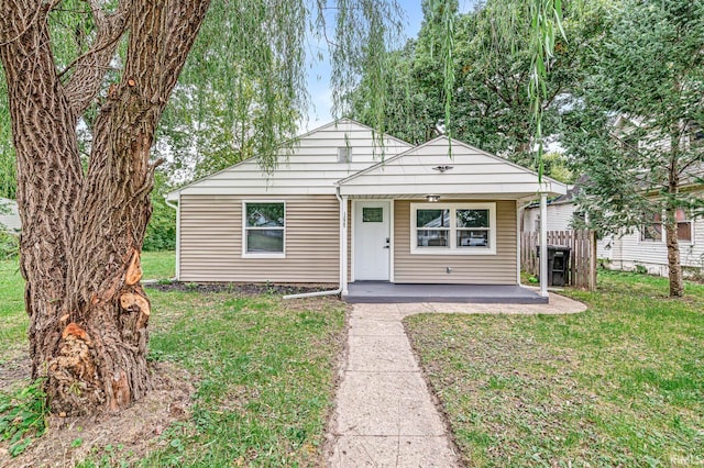 bungalow-style home with a front yard