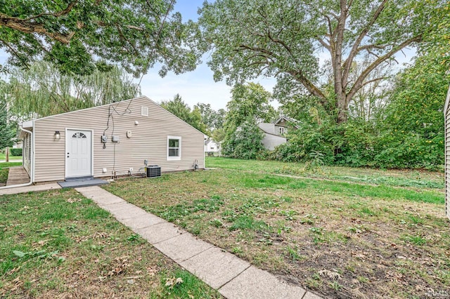 exterior space with central AC and a front lawn