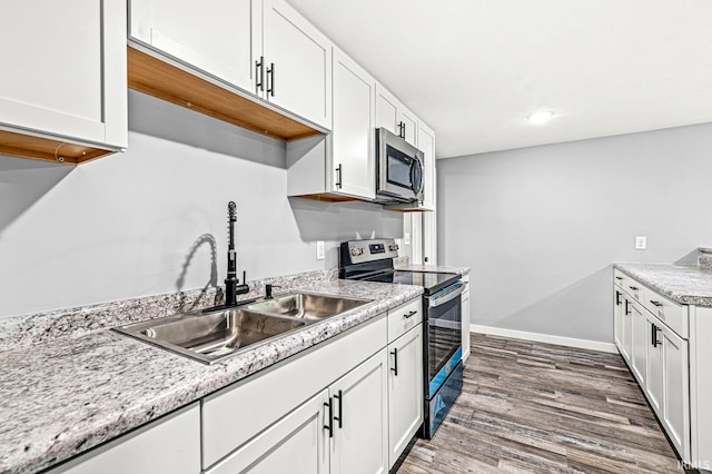 kitchen featuring white cabinets, dark hardwood / wood-style floors, sink, and stainless steel appliances