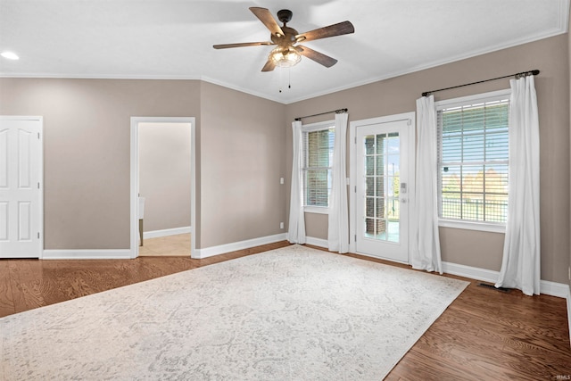 spare room with hardwood / wood-style flooring, ceiling fan, and crown molding