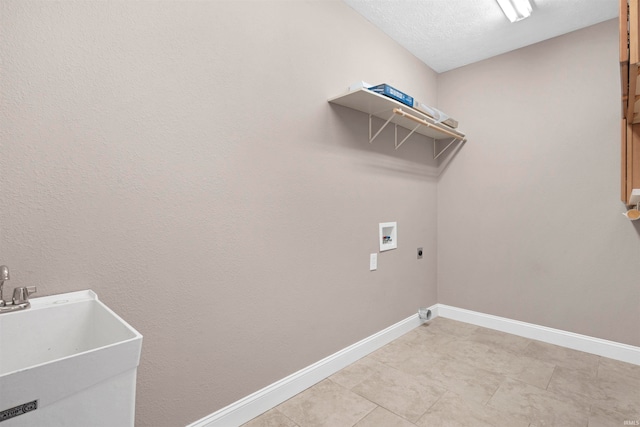 clothes washing area featuring washer hookup, a textured ceiling, electric dryer hookup, sink, and light tile patterned flooring