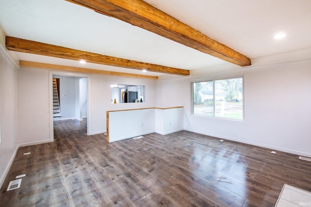 unfurnished room with beamed ceiling and dark hardwood / wood-style floors