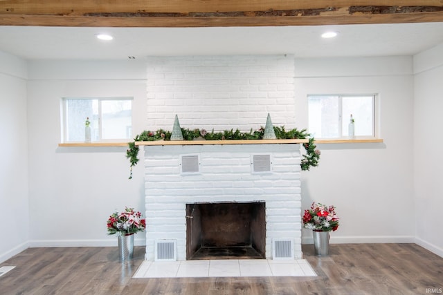 details featuring a fireplace, hardwood / wood-style floors, and beamed ceiling