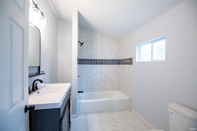 full bathroom with vanity, toilet, tiled shower / bath combo, and vaulted ceiling