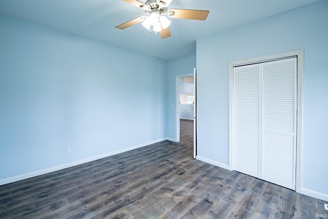 unfurnished bedroom with ceiling fan, a closet, and dark hardwood / wood-style floors