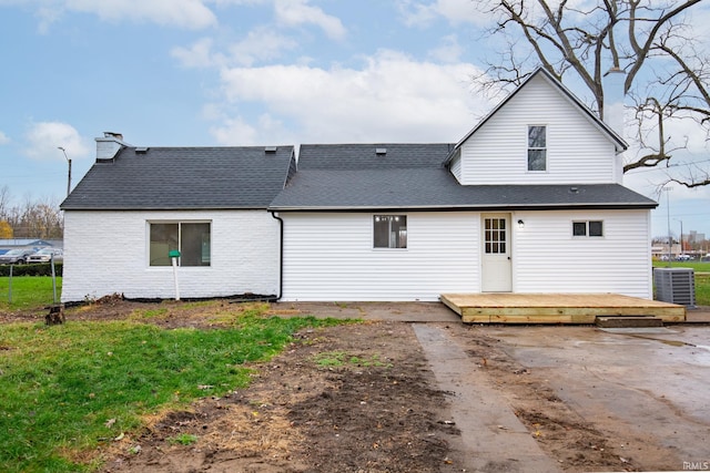 rear view of house featuring cooling unit and a wooden deck