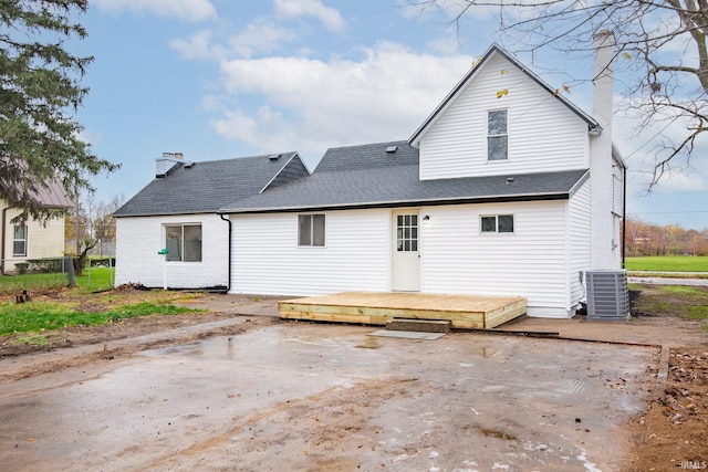 rear view of house with a wooden deck and central AC