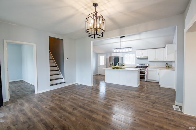 kitchen with white cabinets, dark hardwood / wood-style floors, decorative light fixtures, and appliances with stainless steel finishes