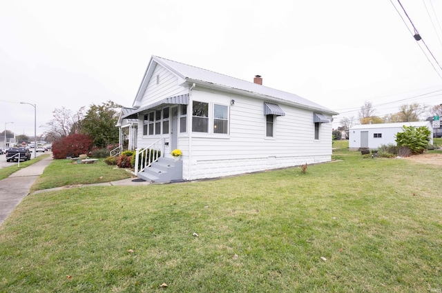 view of side of home with a lawn