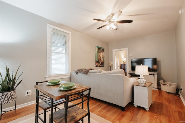 living room with light wood-type flooring and ceiling fan