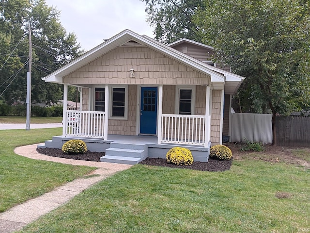 bungalow-style house featuring a porch and a front lawn