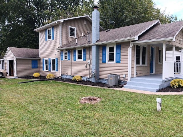 back of property featuring a lawn and central AC unit