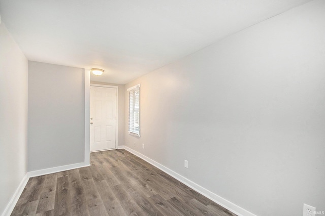 empty room with dark hardwood / wood-style floors