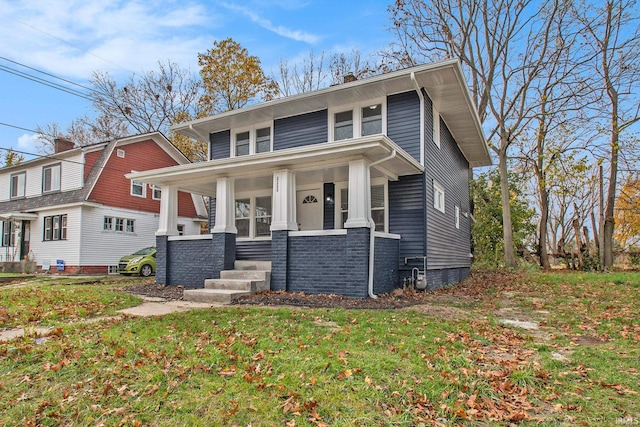 view of front of home featuring a front yard and a porch