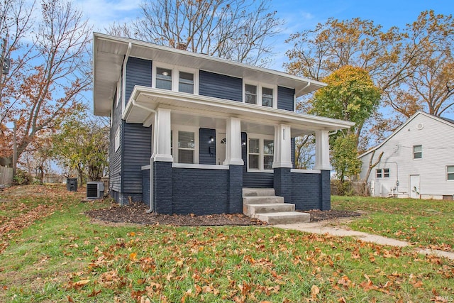 view of front of home featuring a porch, a front lawn, and cooling unit