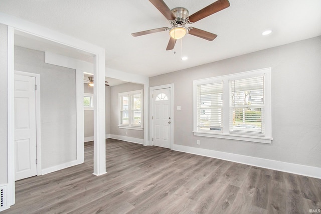 foyer with hardwood / wood-style floors and ceiling fan