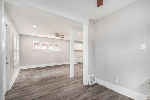 spare room with ceiling fan and dark wood-type flooring