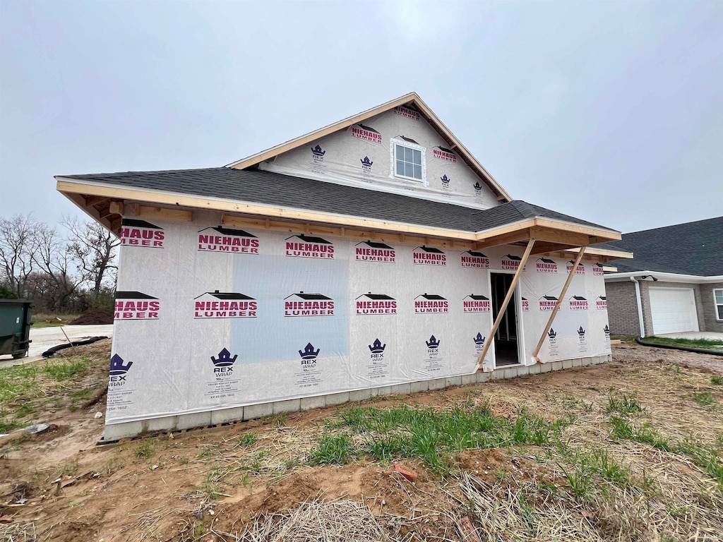 view of side of home featuring a garage