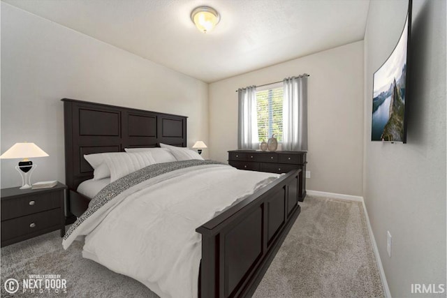 bedroom with light colored carpet