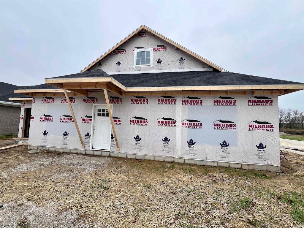 property under construction with roof with shingles