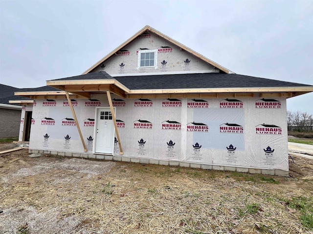 property under construction with roof with shingles