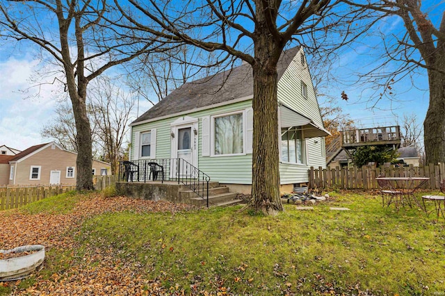 bungalow-style home featuring a front lawn