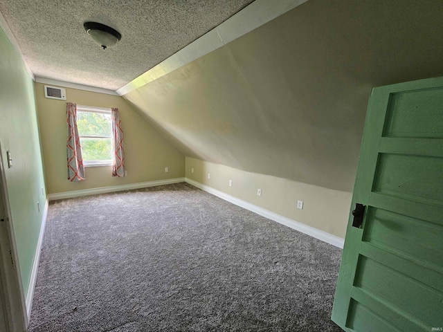 bonus room with lofted ceiling, a textured ceiling, and carpet floors