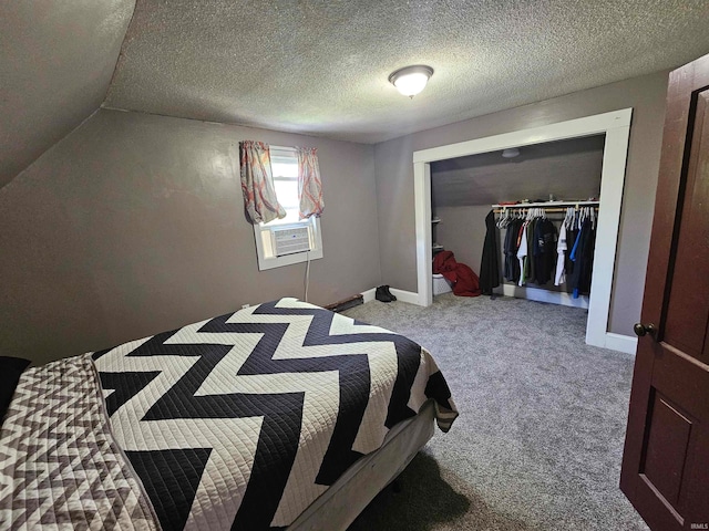 bedroom with a textured ceiling, light colored carpet, a closet, and cooling unit