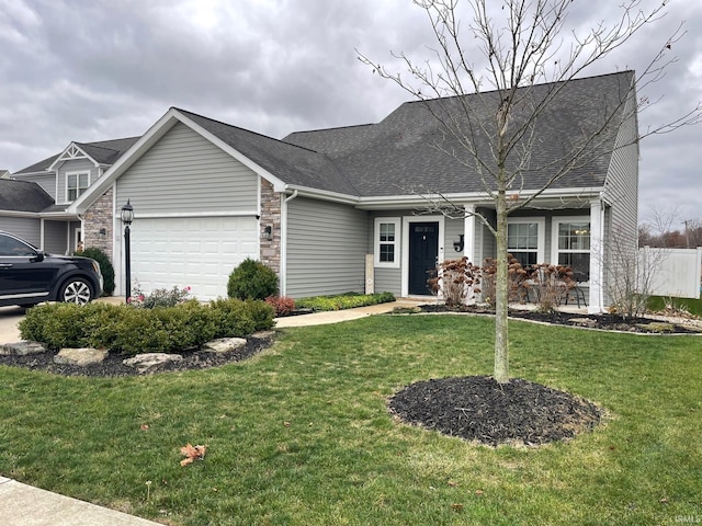 view of front of property featuring a front lawn and a garage