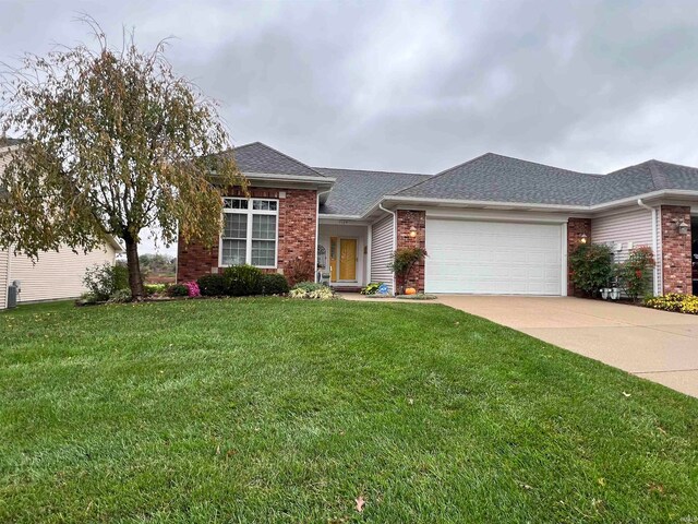 single story home with a front yard and a garage