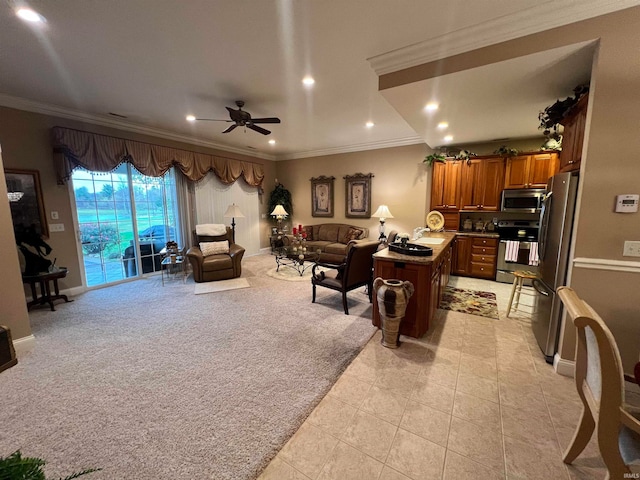 interior space featuring ceiling fan, sink, stainless steel appliances, and ornamental molding