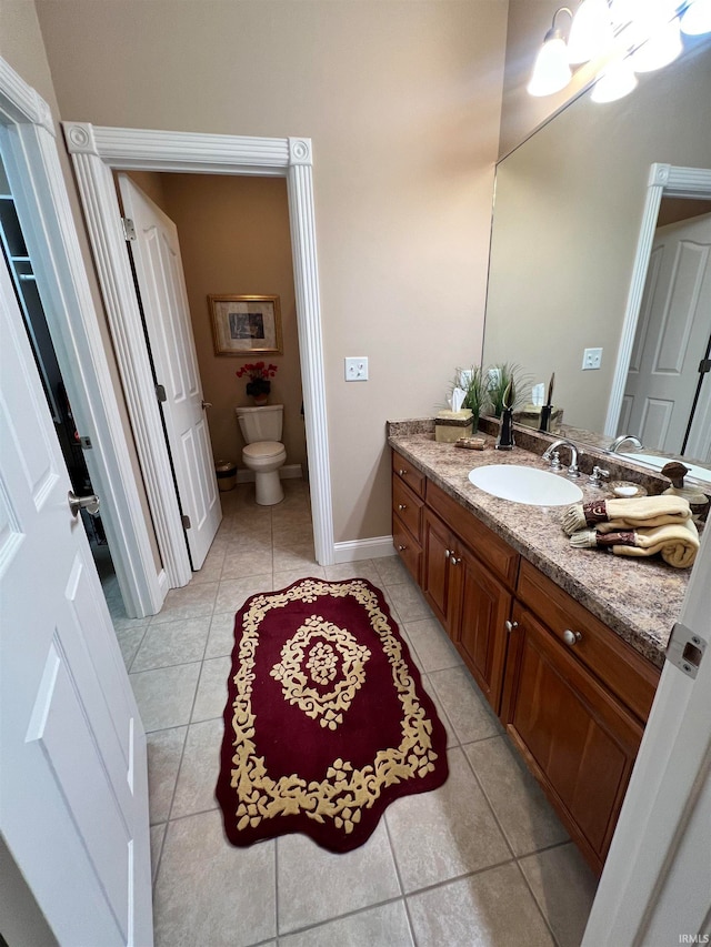 bathroom with tile patterned floors, vanity, and toilet