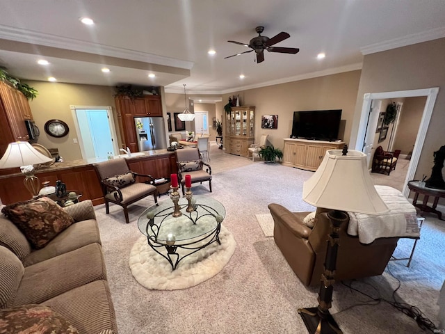 carpeted living room featuring ceiling fan and ornamental molding