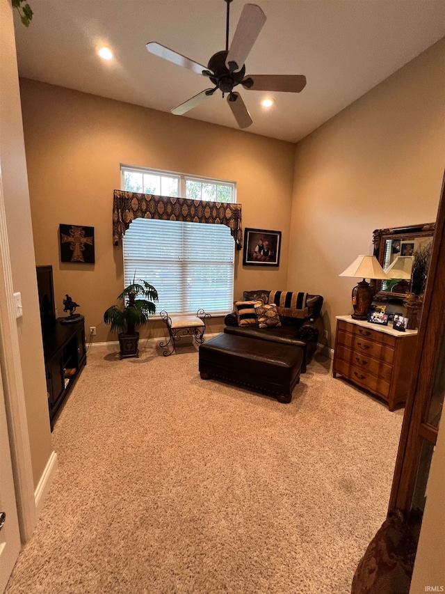 carpeted living room with ceiling fan