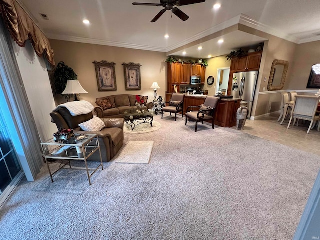 living room featuring ceiling fan, ornamental molding, and light carpet