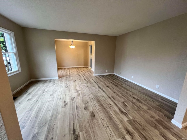 empty room with wood-type flooring