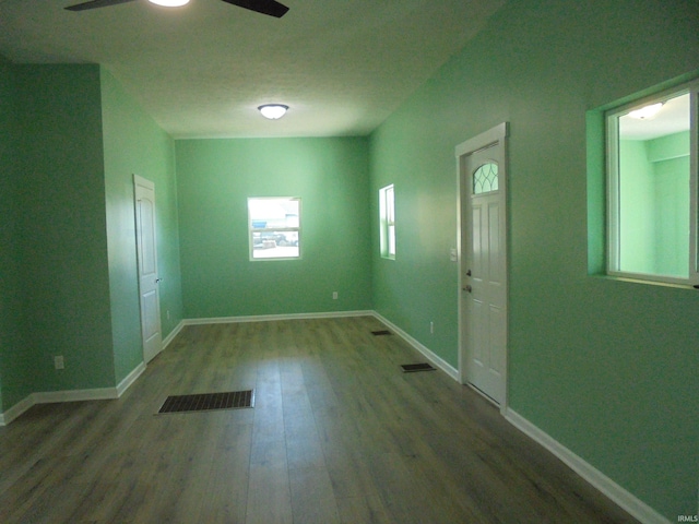 spare room with ceiling fan and dark wood-type flooring