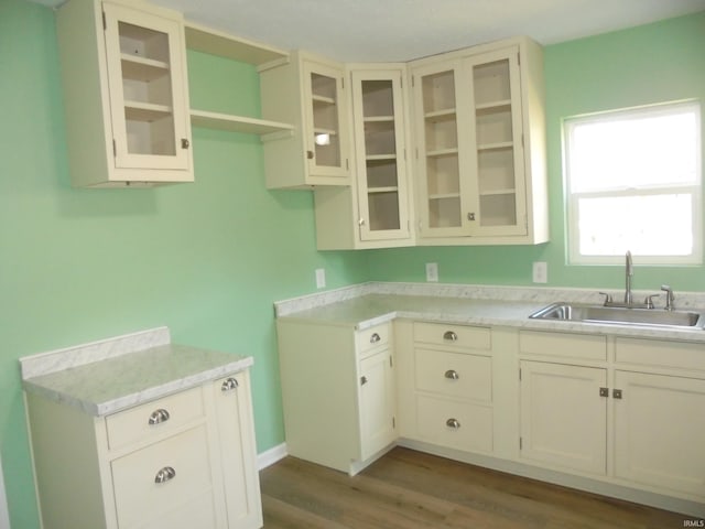 kitchen with sink, wood-type flooring, and cream cabinetry