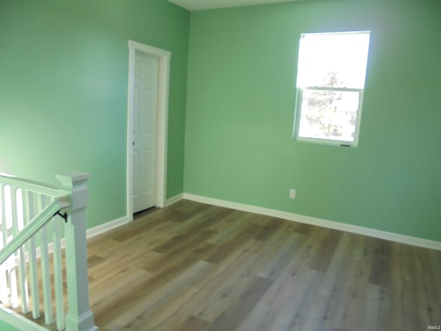 unfurnished room with hardwood / wood-style flooring