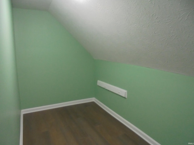 bonus room featuring wood-type flooring and vaulted ceiling