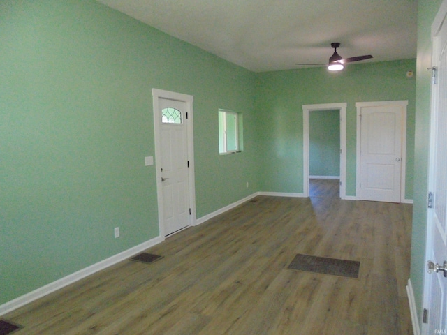 empty room featuring hardwood / wood-style flooring and ceiling fan