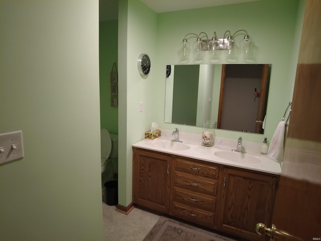 bathroom featuring tile patterned flooring, vanity, and toilet