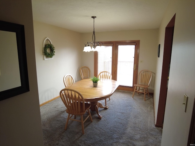 dining space with carpet flooring and an inviting chandelier